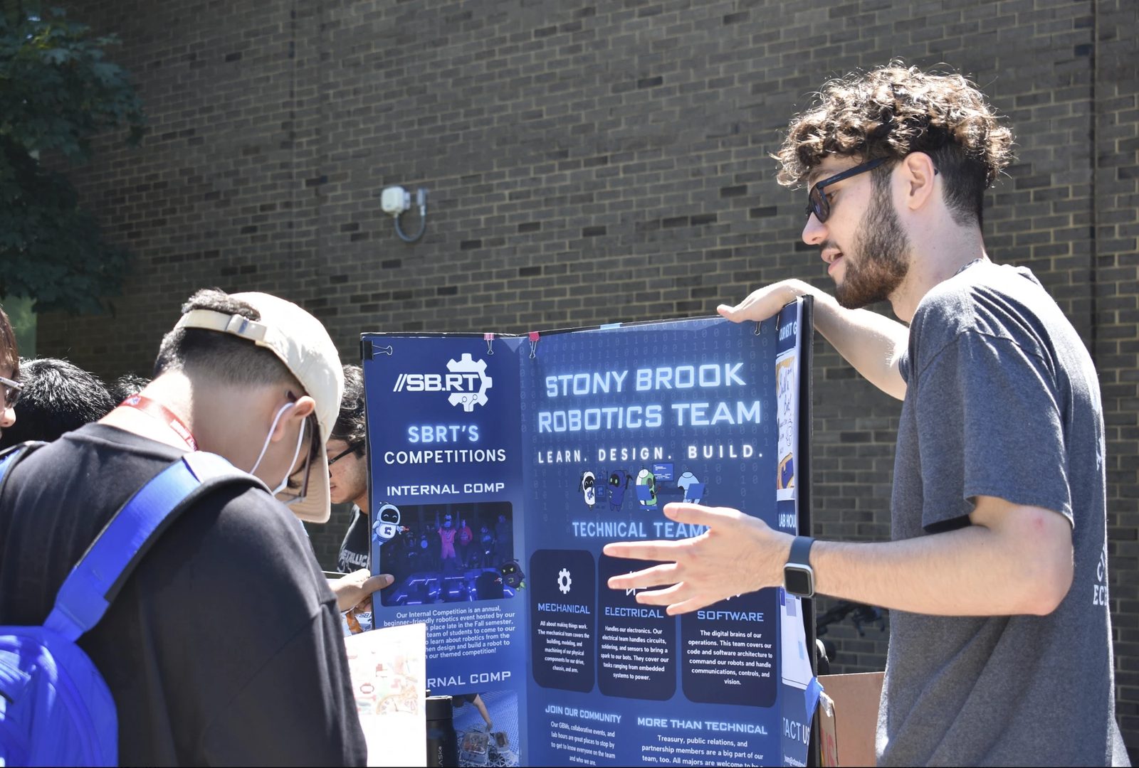 SBRT members tabling with the team poster